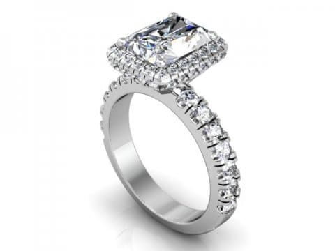 A white gold engagement ring with a cushion cut diamond.